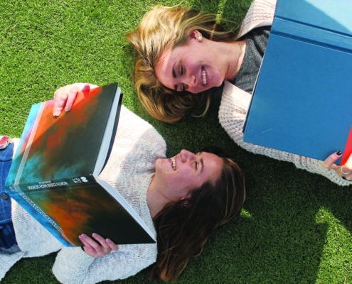 girls-with-books-on-grass